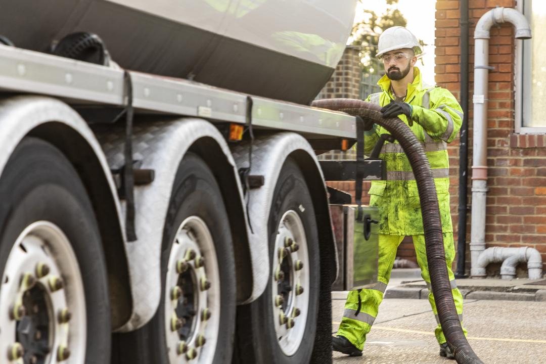 RAF Logistics Driver refuels tanker lorry with petrol pump.